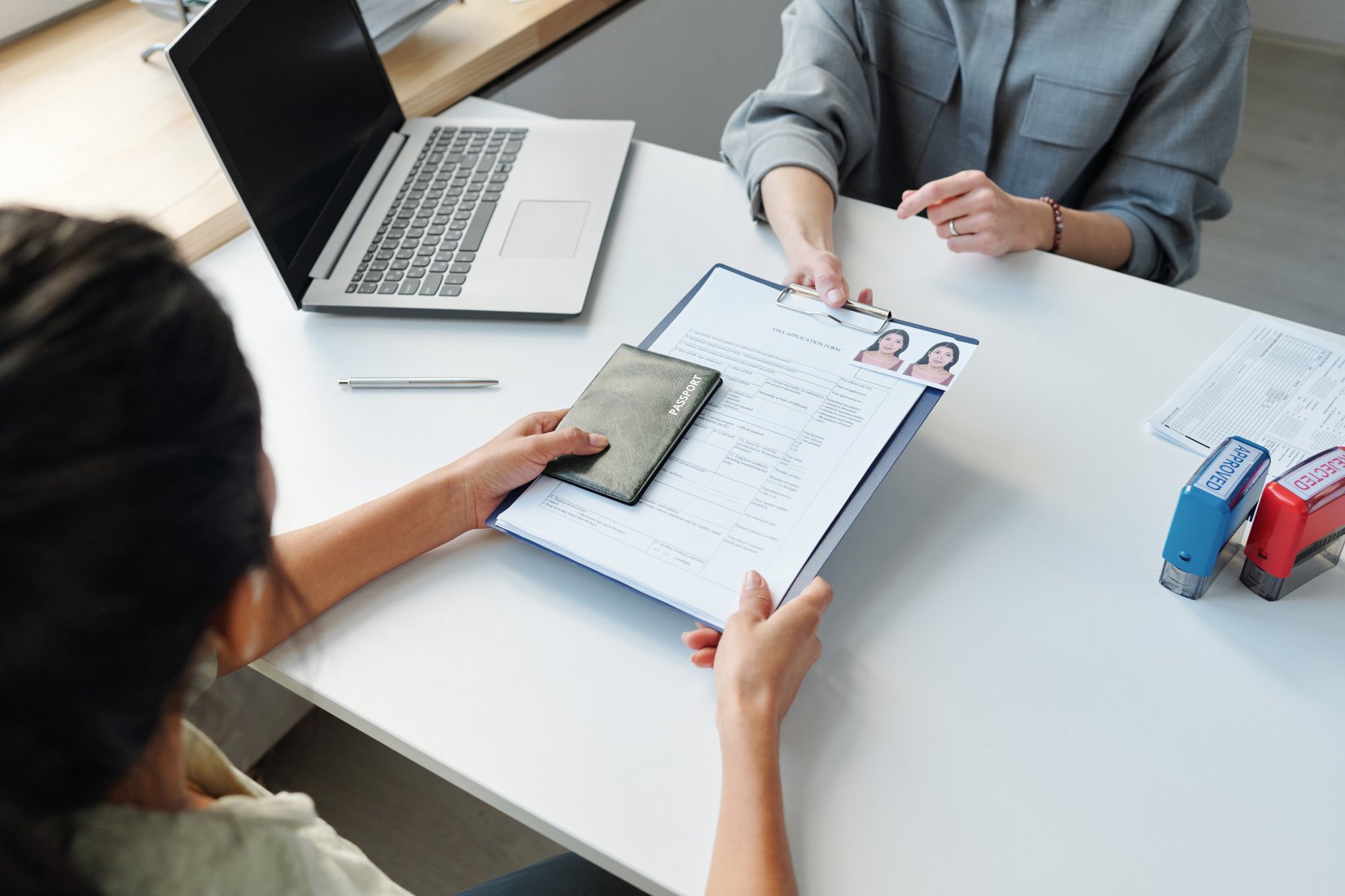 Woman Applying for Visa at Table